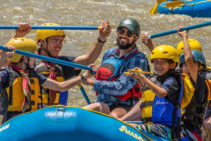 a group of people riding on the back of a boat