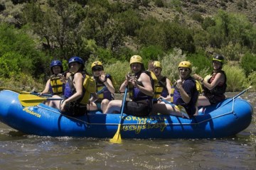 a group of people on a raft in a body of water